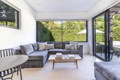 a living room with a couch and a table at Contemporary Apartment With Shared Swimming Pool in Stellenbosch