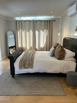 a bedroom with a large bed in front of a window at Guest Suite in Stellenbosch in Stellenbosch