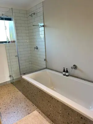 a bath tub in a bathroom with a shower at Guest Suite in Stellenbosch in Stellenbosch