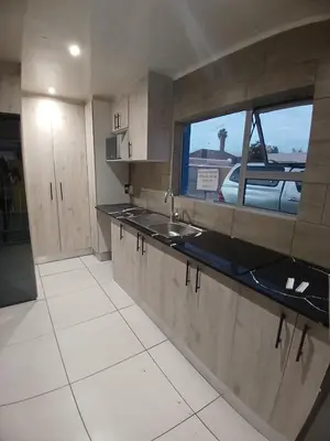 a kitchen with a sink and a window at Neo & Ruks Goodwood 1 in Goodwood