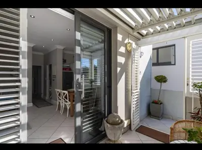a balcony of a house with a glass door at Merweda Wag-n-Bietjie on Dorp Street in Stellenbosch