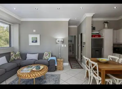 a living room with a couch and a table at Merweda Wag-n-Bietjie on Dorp Street in Stellenbosch