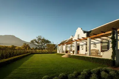 a house with a lawn in front of it at Leeu Estates in Franschhoek