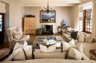 a living room with a couch and a table at Leeu Estates in Franschhoek