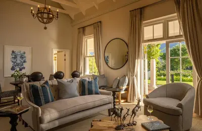 a living room with a couch and two chairs at Leeu Estates in Franschhoek
