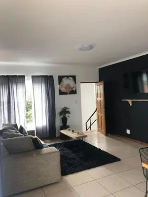 a living room with a couch and a table at Brackenfell self catering accommodation in Brackenfell