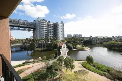 a view of a river with a bridge and buildings at 2 Bedroom Waters Edge Apartment in Century City in Cape Town