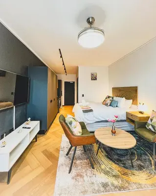 a hotel room with a bed and a living room at Promise on Nine Palms Century in Cape Town