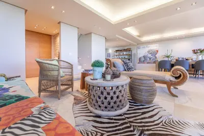 a living room with a couch and a table at Dolphin View Cabana Beach House in Cape Town