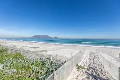 a view of a beach with the ocean at Dolphin View Cabana Beach House in Cape Town