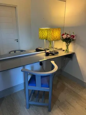 a dressing table with a blue stool and a mirror at Suite Vos in Hermanus