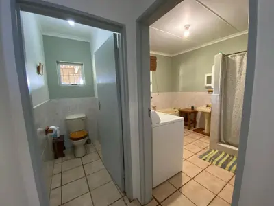 a bathroom with a toilet and a sink at Pik 'n Wyntjie in Bettyʼs Bay