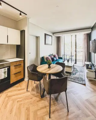 a living room with a table and a couch at Agape Apartment On park Century in Cape Town