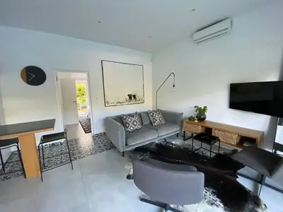 a living room with a couch and a table at Stellenbosch Rozendal Apartment in Stellenbosch