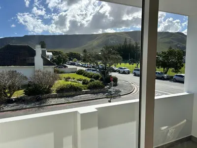 a view of a street from a window of a house at Central Town Duplex with Pool, BBQ & Mountain View in Hermanus