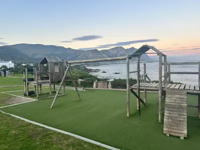 an empty playground with a view of the water at Central Town Duplex with Pool, BBQ & Mountain View in Hermanus