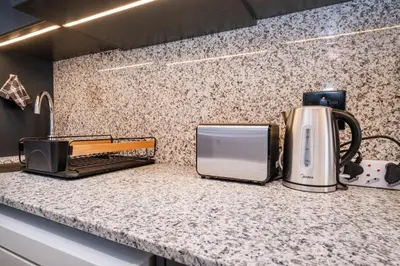 a kitchen counter with a coffee maker and a toaster at Paarl Studio With Onsite Parking & Modern Comforts in Paarl