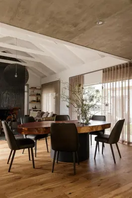 a dining room with a large wooden table and chairs at Tide and Timber Luxury Guesthouse in Hermanus