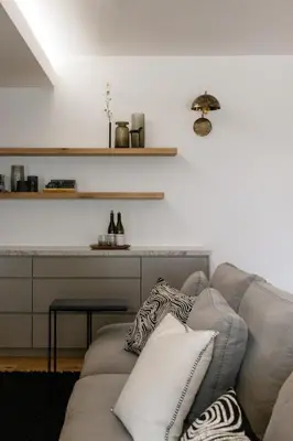 a living room with a couch and a table at Tide and Timber Luxury Guesthouse in Hermanus