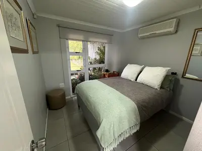 a bedroom with a large bed and a window at Cozy and convenient in Oakdale