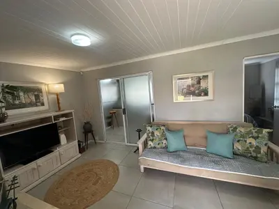 a living room with a couch and a television at Cozy and convenient in Oakdale