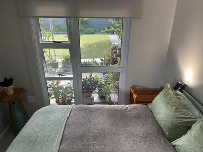 a bedroom with a bed and a large window at Cozy and convenient in Oakdale
