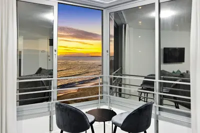 a balcony with chairs and a view of the ocean at Panoramic Seaview @ Strand in Strand