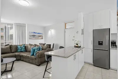 a kitchen and a living room with a couch at Panoramic Seaview @ Strand in Strand