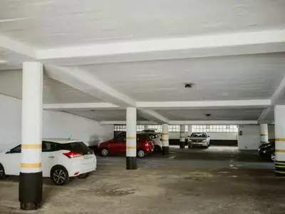 a parking garage with cars parked in it at Panoramic Seaview @ Strand in Strand