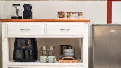 a white cabinet with a coffee maker and a microwave at Rivers Edge Loft in Wellington