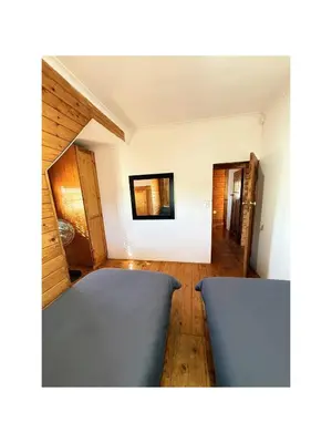 a room with two blue beds in a room at Rihla Residences - Civic Road in Cape Town