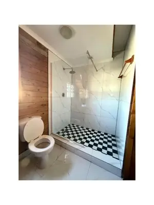 a bathroom with a shower with a toilet at Rihla Residences - Civic Road in Cape Town
