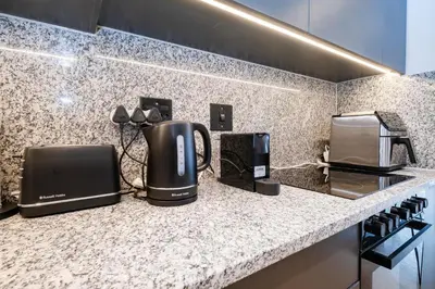 a kitchen with two coffee machines on a counter at Paarl - Lux Modern 2 Bedroom Apartment with Parking in Paarl