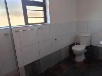 a bathroom with a toilet and a window at Duminy Lodge Monthly Rentals in Bellville