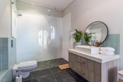 a bathroom with a sink and a toilet and a mirror at Modern Home with Views, Pool & Fireplaces in Estate in the Wineland