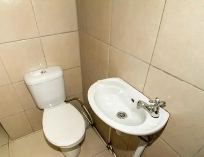 a bathroom with a toilet and a sink at Lodge Luxe, Cozy Bedrooms, Free WiFi, Robust Security in Cape Town