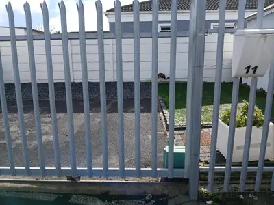 a fence in front of a house at Fisherman's Haven in Bloubergstrand