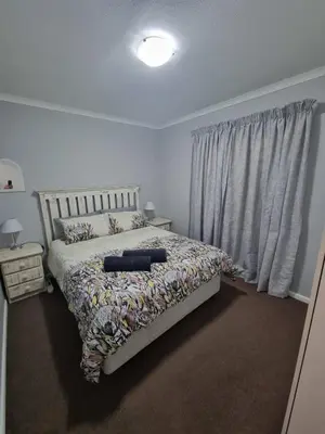 a bedroom with a bed and a window at 180 Mont Blanc in Gordonʼs Bay