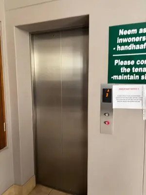 a elevator in a building with a sign on it at At Leisure Apartment 2 in Stellenbosch
