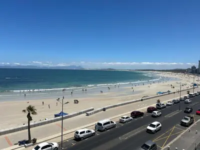 a busy freeway with cars parked on the beach at 401 Pip's Place in Strand