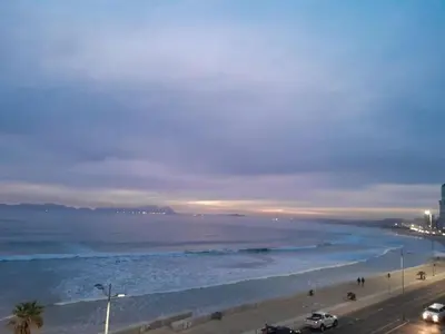 a view of a beach at night with the ocean at 401 Pip's Place in Strand