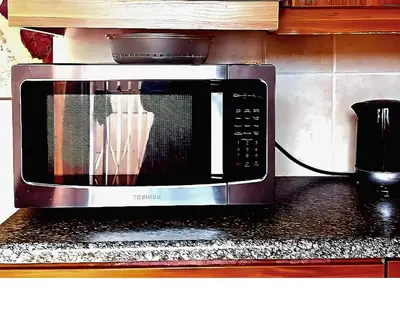 a microwave sitting on top of a kitchen counter at Peace Accommodation B&B in Silver Sands