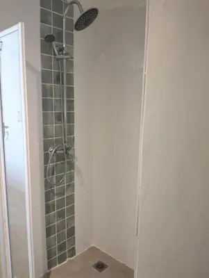 a bathroom with a shower with a glass door at Garden es Cape in Pringle Bay