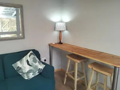 a living room with a table and a couch at Garden es Cape in Pringle Bay