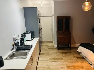 a kitchen with a sink and a counter top at Spacious Bachelor Die Boord in Stellenbosch