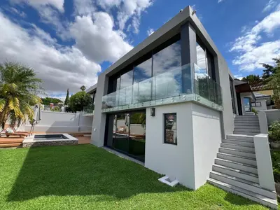 a large white house with a lawn at Villa Victoria in Paarl