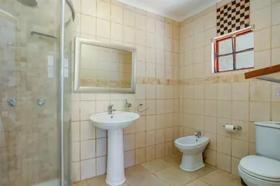 a bathroom with a sink and a toilet and a shower at Calais Wine Estate in Paarl