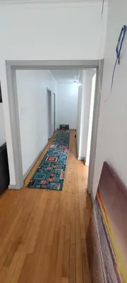 an empty hallway with a rug on a wooden floor at PEACEFUL SLEEP lodge 1 in Goodwood