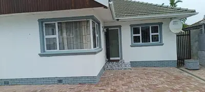 a white house with a window and a door at PEACEFUL SLEEP lodge 1 in Goodwood