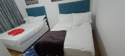 a small bedroom with two beds with white sheets at PEACEFUL SLEEP lodge 1 in Goodwood